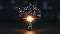 Glowing light bulb with floating business icons and symbols representing innovation, creativity, and strategic thinking for corporate presentations.