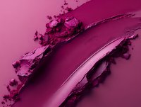Vibrant magenta cosmetic powder smear with crushed makeup texture showing rich pigmentation and smooth blending on pink background, macro photography closeup.