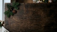 Rustic wooden table with evergreen branches and pinecones, ideal for holiday decorating, seasonal marketing, and festive event planning backgrounds.