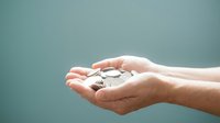 Close-up of open hands holding a small globe, symbolizing global responsibility, environmental care, and sustainable business practices for corporate and eco-friendly designs.
