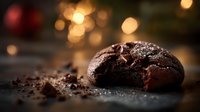 Freshly baked chocolate cookie with cracked surface and melting chocolate chunks against warm bokeh background, perfect for dessert advertising.