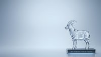 Goat made of crystal glass standing on black pedestal with text against white background, isolated for design use.