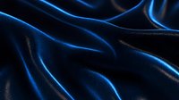Luxurious dark blue silk fabric with elegant folds and waves creating dramatic light effects and glossy reflections. Smooth textile background for luxury designs.