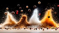 Coffee beans bouncing and creating waves of ground coffee powder with dynamic splashes and sprays against black background, dramatic lighting effect.