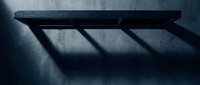 Minimalist black floating shelf casting geometric shadows on textured concrete wall in moody lighting for modern interior design and home decor concepts.