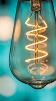 Vintage Edison bulb with spiral filament glowing warmly against turquoise background for modern interior design and creative lighting concepts.