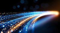 Glowing blue and golden light trails with bokeh effects curve across dark background creating dynamic motion and energy stream for technology concepts.