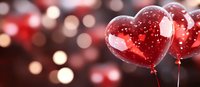 Red heart-shaped balloons floating against blurred bokeh background with romantic glow and sparkle effects, creating festive Valentine's Day atmosphere.