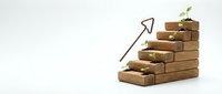 Wooden blocks arranged as ascending stairs with green plant sprout and upward arrow symbolizing growth, success, progress and business development concept.