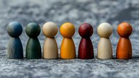 Colorful wooden game pieces lined up showing diversity and teamwork concept on textured background. Metaphor for inclusion, leadership and social unity.