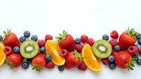 Fresh mixed berries and citrus fruits arranged in colorful row on white background. Healthy organic produce for nutrition and wellness concepts.