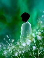 Silhouette of a child standing among glowing white wildflowers against emerald green bokeh background creates dreamy, ethereal atmosphere for fairy tale illustrations.