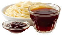 Fresh cooked asian noodles served with dark soy sauce in glass bowl and sweet chili sauce in small dish, isolated on white background for food design.