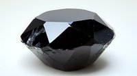 Black polished crystal with geometric facets and sharp angles on white background, natural mineral specimen with glossy reflective surface for jewelry design.