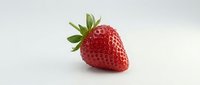 Fresh red strawberry with green leafy crown isolated on white background, suitable for food packaging, recipe blogs, and culinary designs.