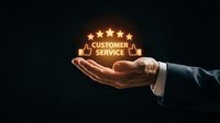 Male hand in business suit holding glowing customer service icon with five stars and thumbs up symbol on dark background for support and satisfaction concepts.