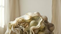 Aged stone sculpture with flowing drapery and classical figures, suitable for art, architecture, museum, and interior design projects.