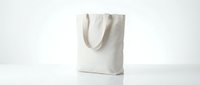Blank white canvas tote bag with handles on clean background for mockup design templates and eco-friendly shopping concepts.