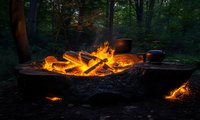Glowing campfire with burning logs and cooking pots in dark forest setting, flames illuminating rustic outdoor kitchen scene at dusk, wilderness camping atmosphere.