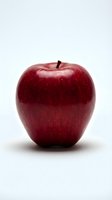 Fresh red apple with glossy skin isolated on white background, suitable for food, nutrition, health and wellness design projects.