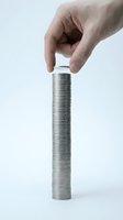 Male hand holding metal threaded bolt and nut against white background. Industrial fastener hardware component for construction, manufacturing, and engineering projects.