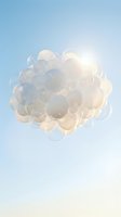 Floating soap bubbles cluster against bright blue sky with sunlight creating dreamy atmosphere for wellness and relaxation concepts.