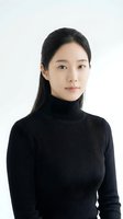 Young Asian woman in black turtleneck sweater portrait on white background for professional headshot and business photography applications.