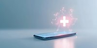 Glowing medical cross hologram floating above smartphone on blue background, futuristic healthcare technology concept for telemedicine and digital health services.
