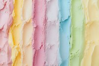 Colorful pastel ice cream scoops in rows creating rainbow pattern with pink, yellow, white, blue and green flavors, macro food photography background.