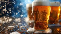 Frosty glass of cold draft beer with foam and condensation drops against blurred bokeh lights background, refreshing golden lager served at bar.