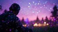 Young man in winter jacket watching magical purple sunset with glowing bokeh lights and snow falling, creating dreamy atmospheric scene in nature.