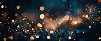 Magical golden bokeh lights and glowing particles floating on dark blue background with sparkles and blurred circles for festive design and holiday decor.
