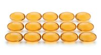 Golden omega-3 fish oil capsules arranged in neat rows on white background. Dietary supplement pills for health and wellness nutrition support.