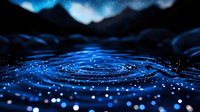 Glowing blue ripples on dark water surface with bokeh light effects and sparkles creating magical nighttime atmosphere against mountain silhouettes.