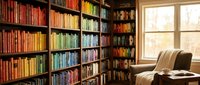 Cozy home library with colorful books organized on wooden shelves, comfortable reading chair by window, warm natural lighting for study and relaxation.