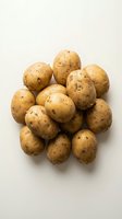 Fresh raw potatoes with natural skin isolated on white background for cooking and food preparation projects.