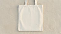 Blank cream cotton tote bag with handles on neutral background, ready for custom design, branding, printing, merchandise, or promotional use.