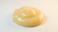 Creamy yellow mustard swirl isolated on white background, ready for food packaging, culinary design, and condiment marketing materials.