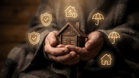 Hands holding wooden house model with glowing insurance icons including shield, umbrella, and home symbols on dark background for protection concept.