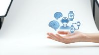 Hands holding digital healthcare icons including brain, heart, medicine bottle, and connected network symbols representing medical technology and wellness solutions.