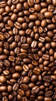 Fresh roasted coffee beans background showing natural brown colors and detailed texture of aromatic whole beans for cafe and coffee shop marketing.