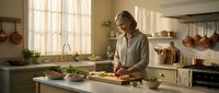 Young woman preparing fresh vegetables in rustic farmhouse kitchen with natural lighting and copper cookware for healthy home cooking lifestyle.