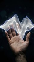 Open hands releasing glowing white energy waves against dark background symbolizing power, spirituality, healing and supernatural abilities.