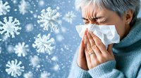Asian senior woman wearing protective face mask sneezing, surrounded by floating virus particles in blue winter background. Healthcare concept during flu season.