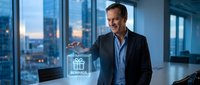 Middle-aged Caucasian male businessman in dark blazer and blue shirt presenting rewards program hologram in modern high-rise office with city skyline view at dusk.