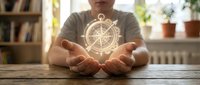 Young woman with cupped hands presenting glowing golden compass rose symbol above wooden table in bright home interior for navigation and direction concepts.