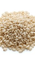 Pile of uncooked white rice grains isolated on white background, suitable for food packaging, culinary websites, nutrition education, and cooking blogs.