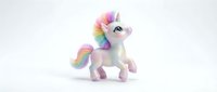 Cute white unicorn toy with rainbow mane and tail isolated on white background for children design projects and fantasy themed decorations.