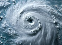 Aerial view of massive hurricane spiral formation over ocean waters showing distinct eye and cloud bands. Dramatic weather phenomenon captured from space.