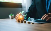 Businessman using calculator with growing plant sprouting from coins stack representing sustainable investment growth and green finance planning.